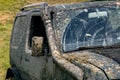 A dirty car covered with a layer of swamp spray as a result of off-road driving. Royalty Free Stock Photo