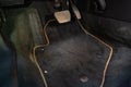 Dirty car floor mats of black carpet with gas pedals and brakes in the workshop for the detailing vehicle before dry Royalty Free Stock Photo