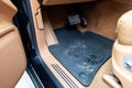 car floor mats of black rubber with gas pedals and brakes in the workshop for the detailing vehicle before dry cleaning