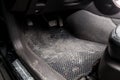 Dirty car floor mats of rubber with gas pedals and brakes in the workshop for the detailing vehicle before dry cleaning Royalty Free Stock Photo