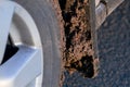 Dirty car mudflap on the front wheel splashed with a mud. Royalty Free Stock Photo