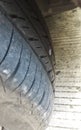 a dirty car tire punctured by a small nail Royalty Free Stock Photo