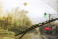Dirty car windshield with the included glass cleaner, in the big city front and back of the background is blurred