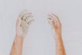 Dirty of clay and mud man hands isolated on white. Creative and abstract photo of human hands. Delicate humanity. Selective focus