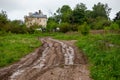 Dirty clay mud road with puddles and tire tracks - closeup with selective focus and linear perspective Royalty Free Stock Photo