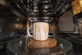 dirty coffee cup after operating with microwave oven, heating water in microwave can be dangerous,