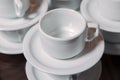 Dirty coffee cup and spoon setting on white saucer and wooden table after drinking in the morning in vintage style Royalty Free Stock Photo