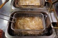 Dirty cooking area with french fries deep fryer. Royalty Free Stock Photo