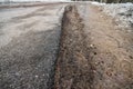 Dirty curb spring asphalt road in perspective