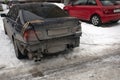 Dirty and damaged auto sedan parked on winter street, Back bamper is missing, trunk is fixed with duct tape. Russia, 29.02.2020