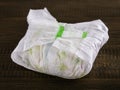 Dirty diaper on dark wooden background Royalty Free Stock Photo