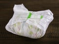 Dirty diaper on wooden background Royalty Free Stock Photo