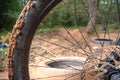 Dirty disc brake front wheel of a mountain bike on a trail in the forest Royalty Free Stock Photo