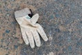 Dirty, discarded sports glove on the ground