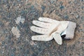 Dirty, discarded sports glove on the ground