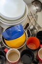 Dirty dishes in a ceramic kitchen sink. Unwashed plates, mugs and cutlery. Top view Royalty Free Stock Photo