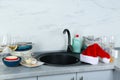Dirty dishes near sink in kitchen Royalty Free Stock Photo