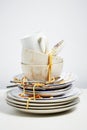 Dirty dishes pile needing washing up on white background Royalty Free Stock Photo