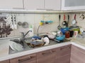 dirty dishes in the sink in the kitchen, lack of water in the water supply and violation of the usual way of life Royalty Free Stock Photo