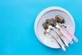 Dirty dishes with spoon and fork on blue background Royalty Free Stock Photo