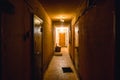 Dirty empty dark corridor in apartment building, doors, lighting lamps Royalty Free Stock Photo
