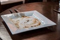Dirty empty dish and spoons on wooden table. Royalty Free Stock Photo