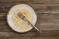 A dirty empty plate on wooden table after dinner Royalty Free Stock Photo