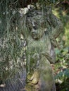 Dirty face of little cupid angel sculpture statue. Royalty Free Stock Photo