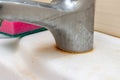 Dirty faucet with limescale, calcified water tap with lime scale and a sponge on washbowl in bathroom, close up, house cleaning Royalty Free Stock Photo