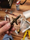 Dirty Fingers Holding Broken Bolt