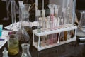 dirty flasks. Chemical laboratory and a shelf with bottles on the background of physical formulas.