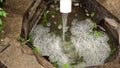 Dirty, foamy, wastewater flows out of pipe