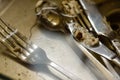 Dirty fork knife and spoon covered with icing under water inside kitchen sink Royalty Free Stock Photo