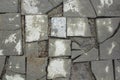 Dirty gray broken square tile of different shapes and sizes in the ground top view. rough surface texture Royalty Free Stock Photo