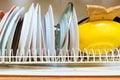 Dirty grubby drainer with clean dishes in kitchen. Royalty Free Stock Photo