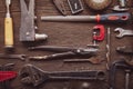 Dirty grungy set of hand tools on a wooden panel, Flat lay, Pliers screwdriver wrench rusted iron metal Royalty Free Stock Photo