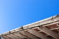 Dirty Gutter and Roof Trusses against blue sky