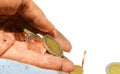 A dirty hand carrying coins on the white floor background. Royalty Free Stock Photo