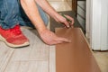 Dirty hand of a person working that has several fingers amputated. Person with dirty clothes laying a floor in his house. Physical