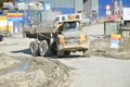 Dirty heavy Volvo dumper loaded by rock moving in work site. There is slovak highway labeled D1 under construction. Royalty Free Stock Photo