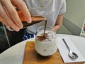 Dirty iced latte pouring espresso shot to white full cream cow milk in cozy coffee shop Royalty Free Stock Photo