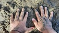 Dirty kids hands playing sands at the beach. Kids hand on sandy beach. Concept of children playing outdoor Royalty Free Stock Photo