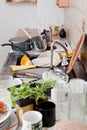 Dirty kitchen with crockery, leftovers, messy kitchenware