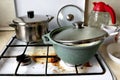 Dirty kitchen. Dirty gas stove with food debris and grease splashes. Dirty dishes Royalty Free Stock Photo