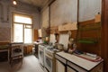 Dirty kitchen with furniture and gas stoves is in the apartment for temporary living existence refugees who were forced to mig Royalty Free Stock Photo