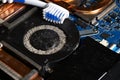 Dirty laptop computer fan full of dust and needs cleaning using a toothbrush Royalty Free Stock Photo