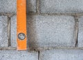 Dirty level ruler is hanging near the brick wall. Royalty Free Stock Photo