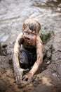 Dirty Little Boy Child Playing in Mud while Swimming in the Rive