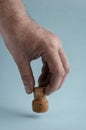 Dirty Male hand holds champagne cork