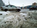 Dirty melted snow on a road. Winter is here. Snowfall in city. Problem of street snow removal. Mess. Chilly. Cityscape. Blurred to